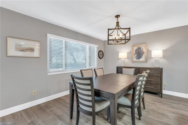 Dining room featuring a chandelier and wood-type flooring