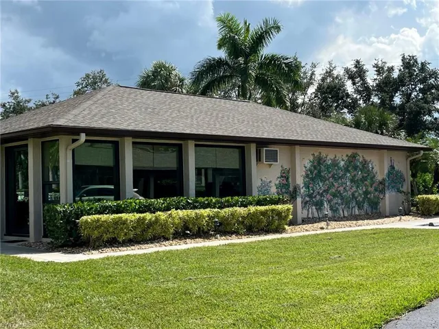 Single story home featuring a front lawn