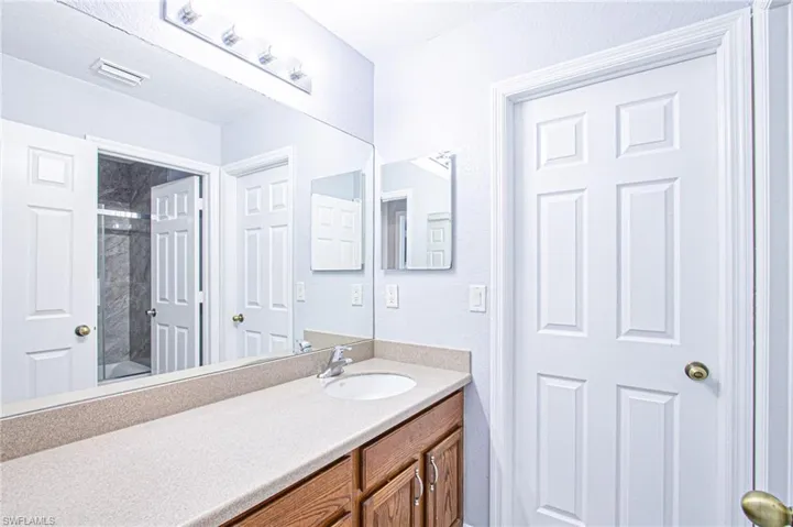 Bathroom with vanity and tub / shower combination