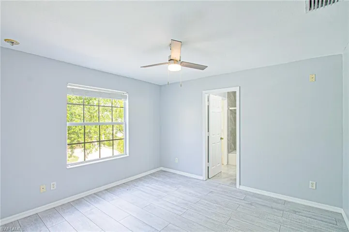 Spare room with light wood finished floors and ceiling fan