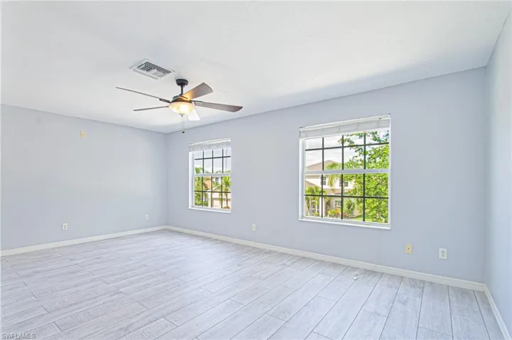 Spare room featuring wood finish floors and ceiling fan