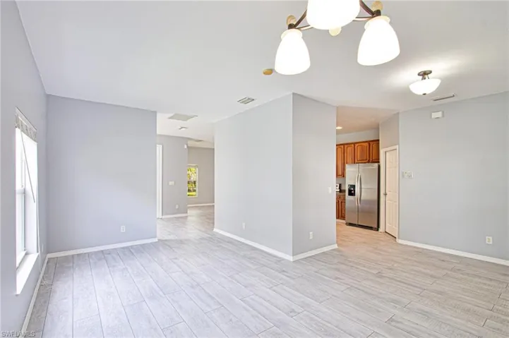 Spare room with light wood-type flooring and baseboards