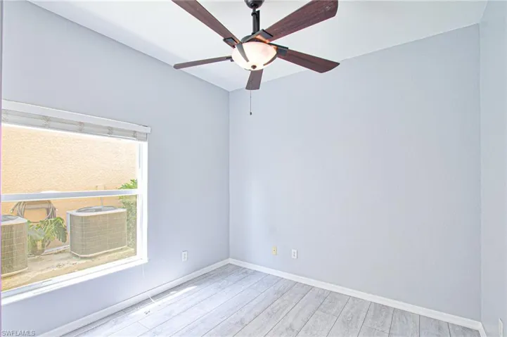 Spare room featuring wood finished floors and a ceiling fan