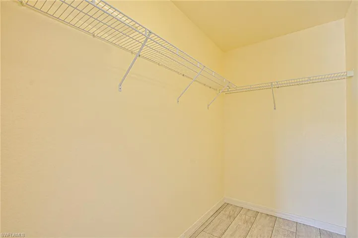 Spacious closet featuring light wood-style floors