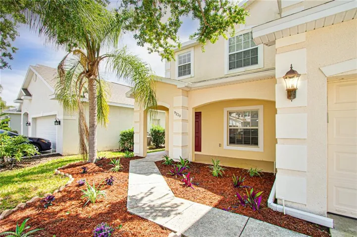Doorway to property featuring stucco siding and a garage