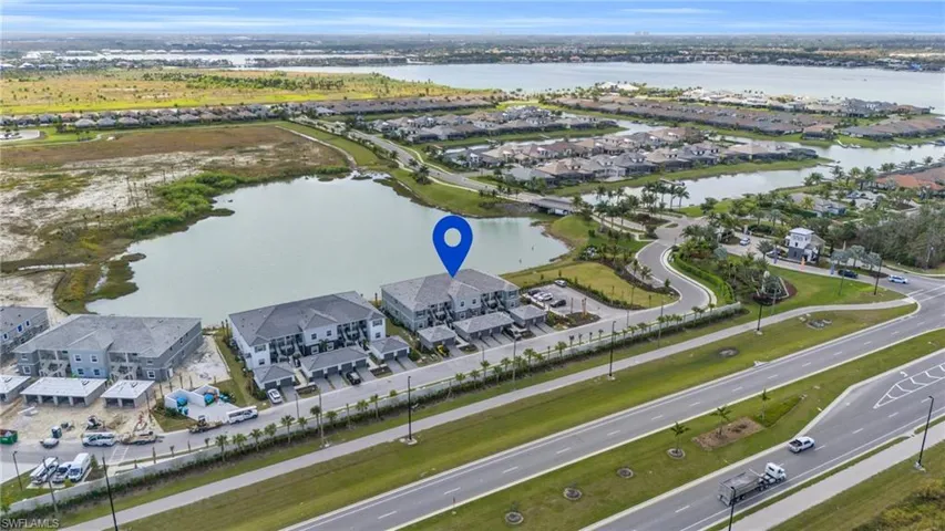 Aerial view featuring a water view and a residential view