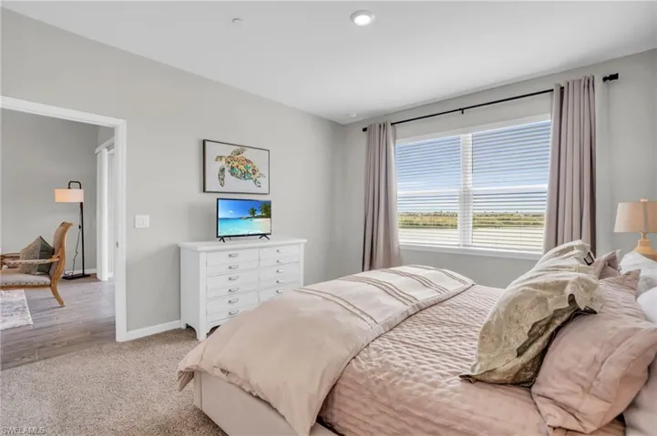 Bedroom featuring baseboards and light colored carpet