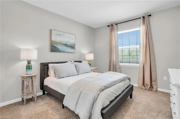 Carpeted bedroom featuring baseboards