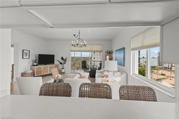 Living room featuring plenty of natural light and an inviting chandelier