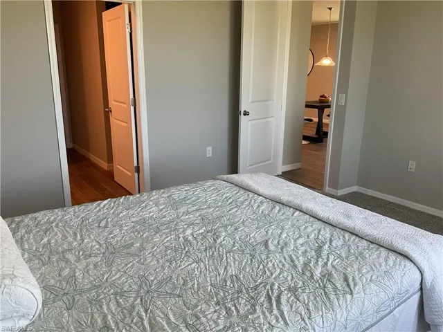 Bedroom with baseboards and wood finished floors