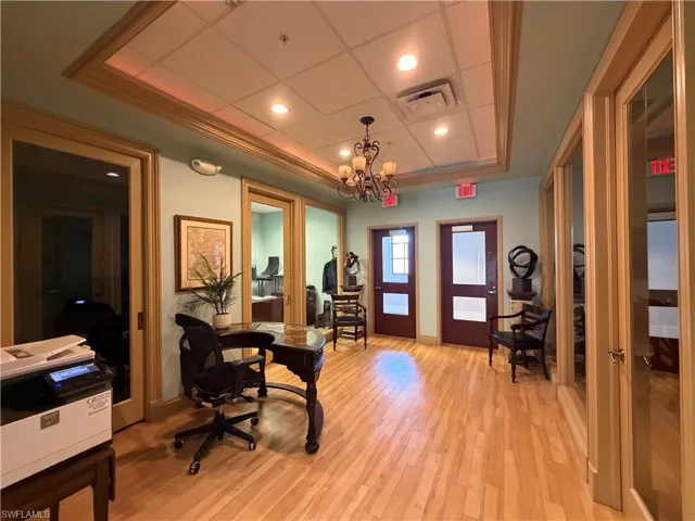 Entryway featuring wood-finish flooring, recessed lighting, a decorative chandelier, and multiple paneled doors with clear glass inserts
