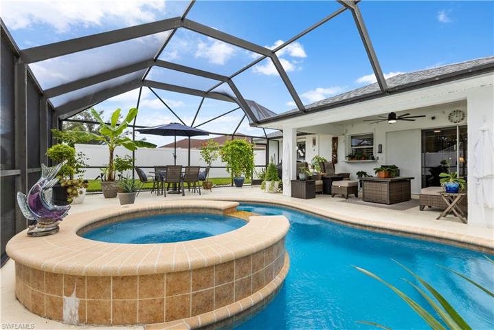 newly redone pool and spa under expansive screened cage