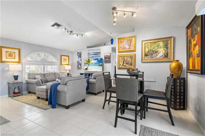 dining area next to slider to lanai, kitchen, and living room