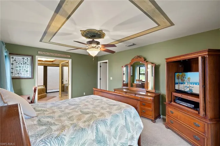 Carpeted bedroom with ceiling fan