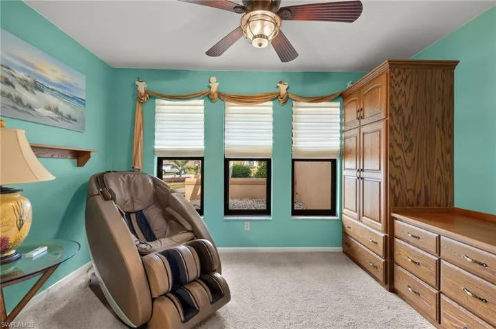 Living area featuring carpet floors and ceiling fan