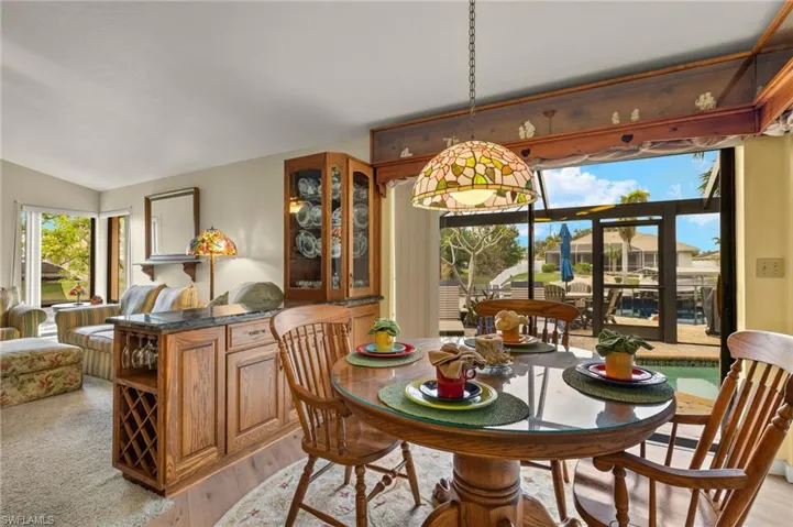 Dining space featuring vaulted ceiling and light hardwood / wood-style flooring