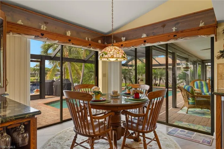 Sunroom / solarium featuring lofted ceiling