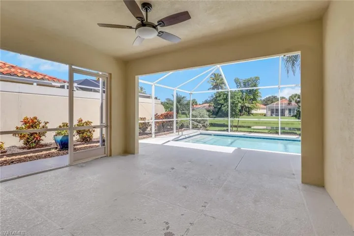 Screened lanai featuring a ceiling fan, tiled flooring, and a swimming pool