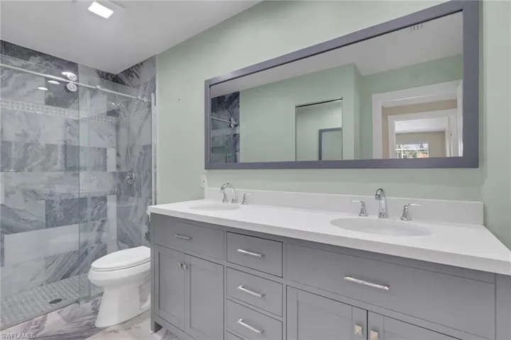 Gray dual vanity with chrome hardware and white countertop