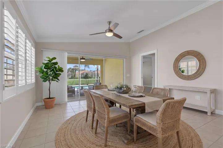 Neutral wall palette with crown molding and ceiling fan