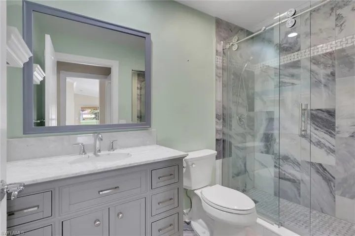 Vanity with a light-toned countertop, undermount sink, and polished chrome fixtures