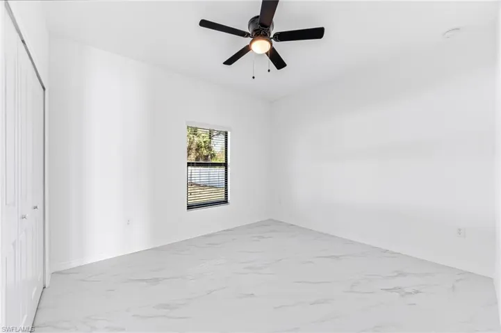Unfurnished room featuring ceiling fan