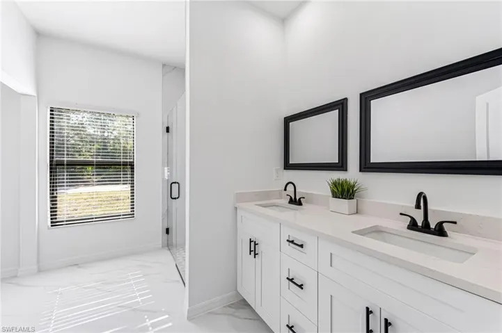 Bathroom featuring vanity and an enclosed shower