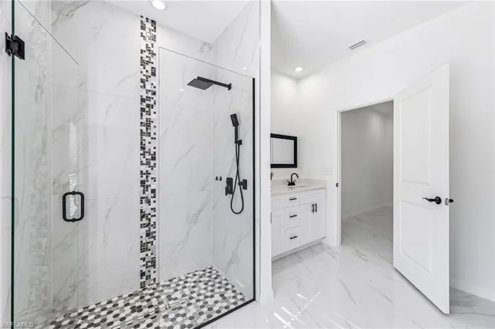 Bathroom with vanity and a shower with shower door