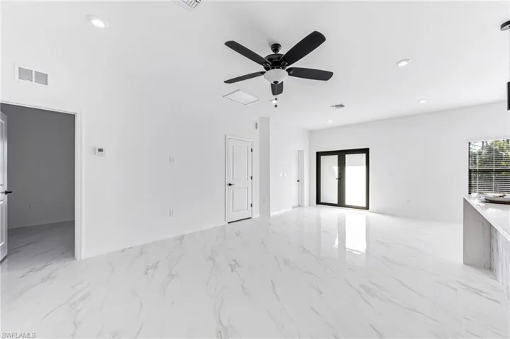 Unfurnished room with french doors and ceiling fan