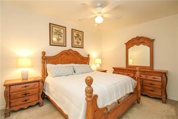 Carpeted bedroom with ceiling fan
