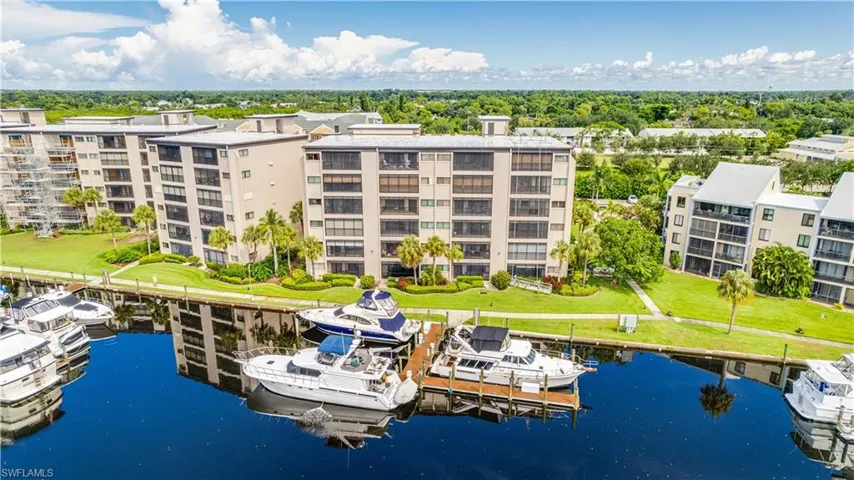 Waterfront condominium complex featuring multiple stories and private boat docks