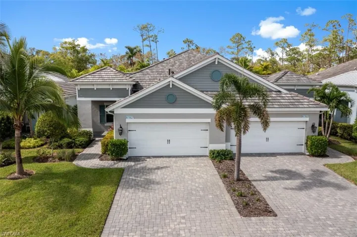 View of front of home with a garage and a front yard