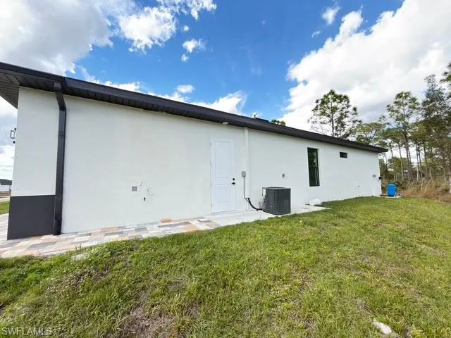 Back of property with stucco siding and a patio area