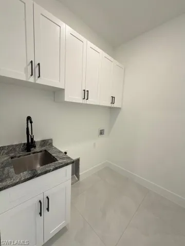 Unfurnished living room with a tray ceiling, recessed lighting, ceiling fan, and light marble finish flooring