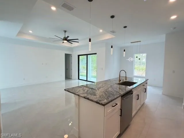 Kitchen featuring hanging light fixtures, dark stone countertops, appliances with stainless steel finishes, tasteful backsplash, and recessed lighting