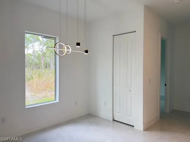 Spare room featuring baseboards
