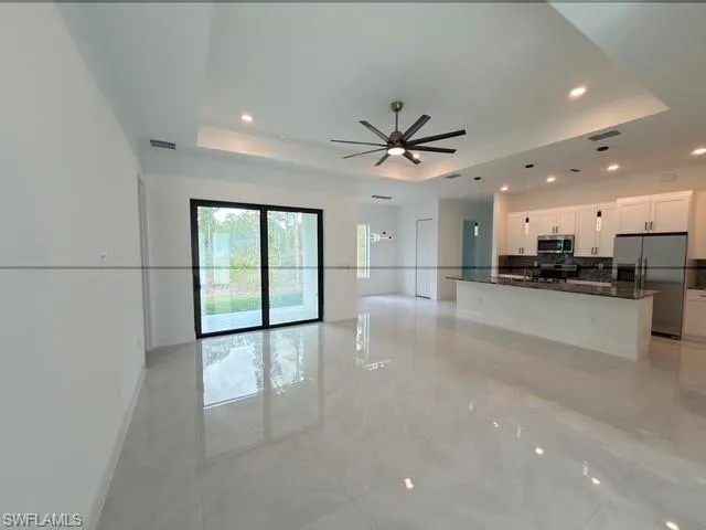 Unfurnished dining area with light tile patterned floors and baseboards