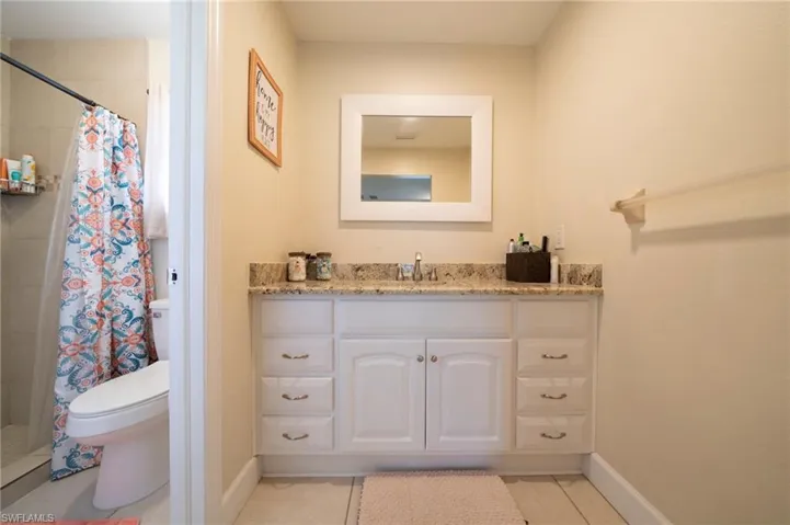 Full bath featuring vanity, a shower stall, and light tile patterned floors