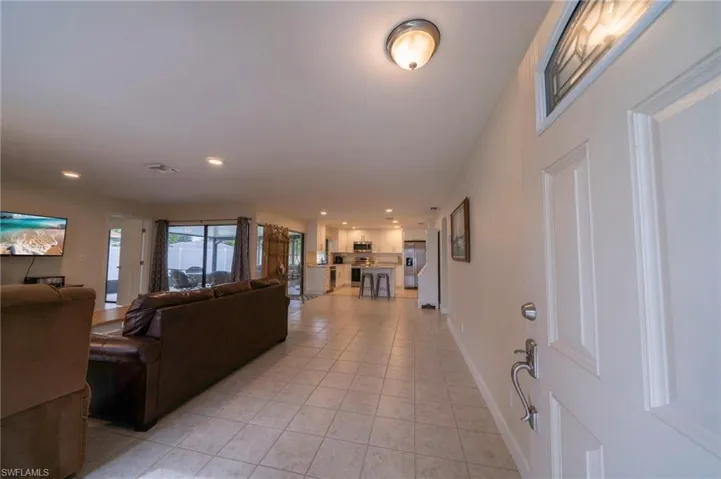 Living area featuring recessed lighting and light tile patterned floors