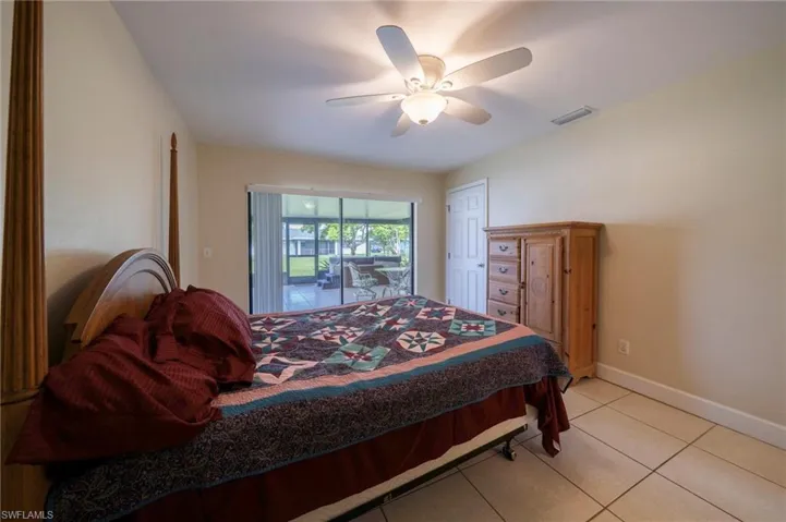 Bedroom featuring tile patterned flooring, access to exterior, and ceiling fan