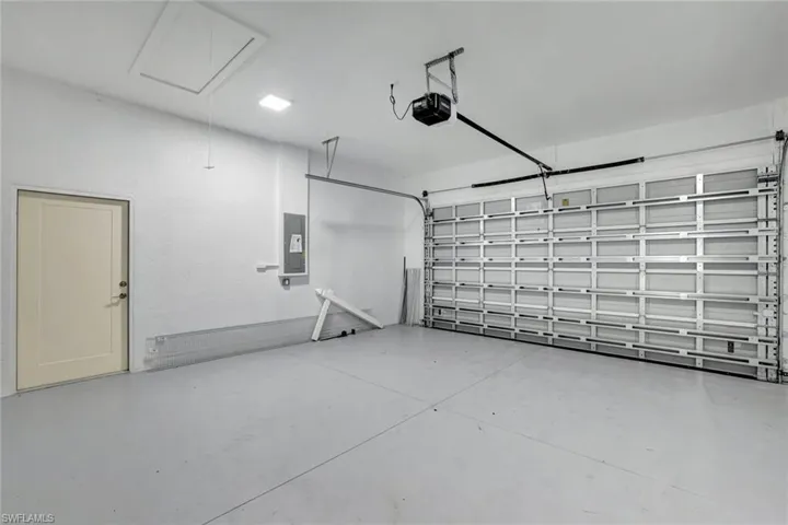 Garage with a garage door opener and electric panel