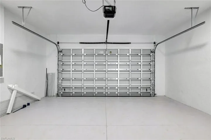 Garage featuring a garage door opener