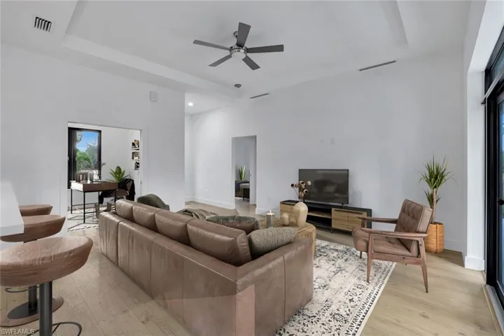 Virtually Staged-Living room with ceiling fan and light hardwood / wood-style flooring