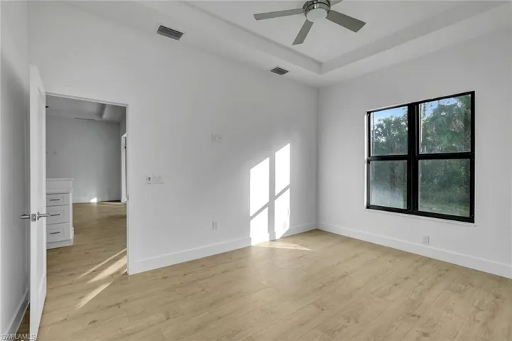 Empty room featuring ceiling fan and light wood-type flooring