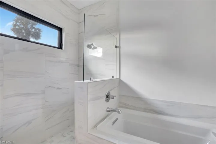Bathroom featuring separate shower and tub