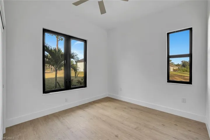 Unfurnished room with ceiling fan and light wood-type flooring