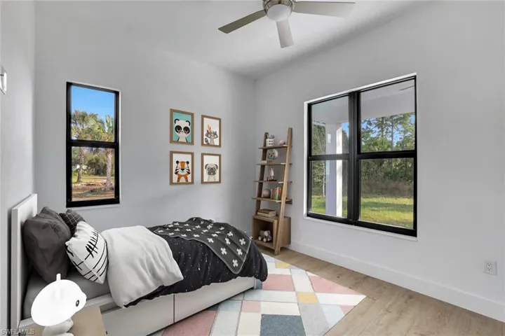 Virtually Staged_Bedroom with multiple windows, light hardwood / wood-style flooring, and ceiling fan