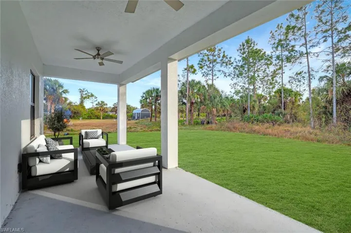 Virtually Staged_View of patio with ceiling fan and an outdoor hangout area