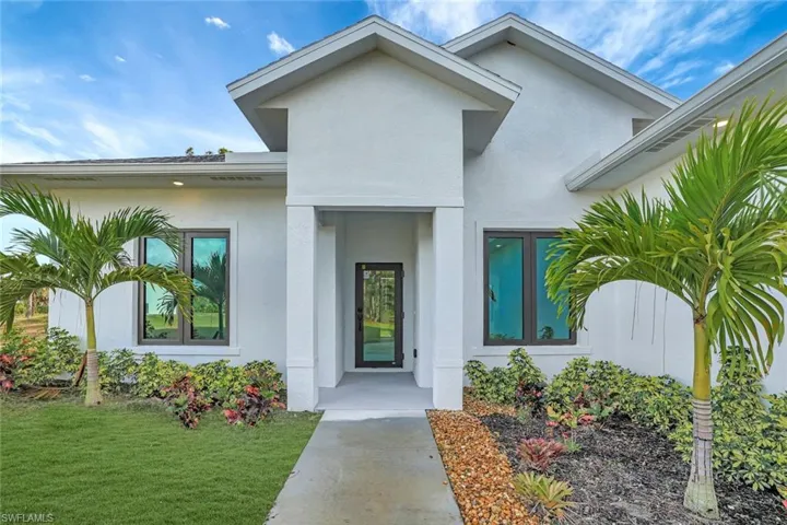 Doorway to property with a yard