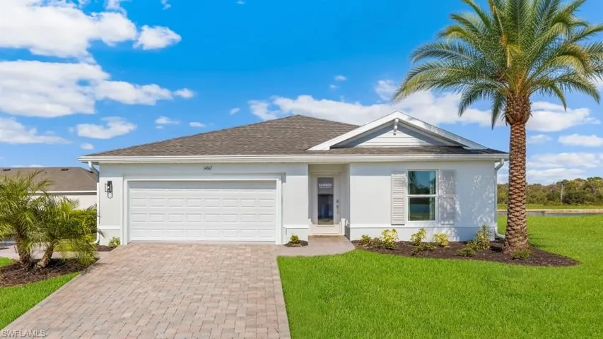 Model home. Ranch-style home with stucco siding, a garage, and decorative driveway